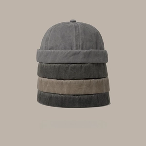 Vertical stack of four docker hats in charcoal, grey, black and khaki washed cotton