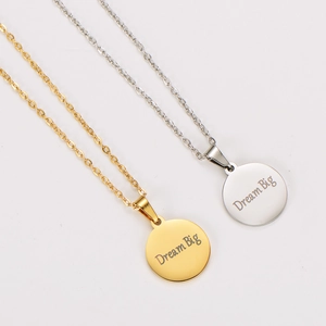 Polished 18k gold and silver Dream Big engraved circular pendant necklaces on O-chain