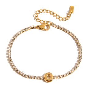 Detail of 18K gold letter O pendant bracelet with sparkling zircon stones on white background