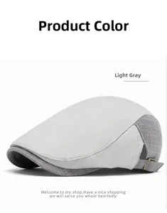 Detail of light gray flat cap featuring adjustable metal buckle and breathable texture