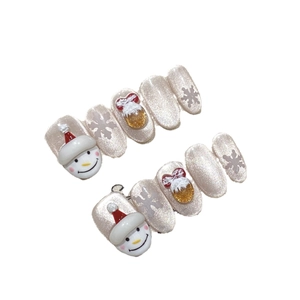 Handcrafted Christmas press-on nails featuring 3D snowman and snowflake designs