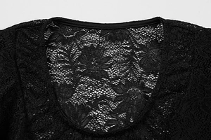 Détail du col rond en dentelle noire avec motifs floraux ajourés et texture délicate