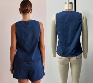 Rear view detail of dark blue sleeveless denim vest and matching high-waisted shorts set