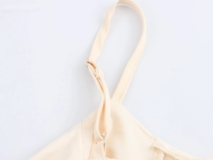 Detail of adjustable metal buckle and strap on an elegant beige French dress