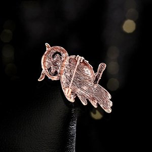 Back view of luxury rose gold owl brooch with woven texture and secure pin fastening