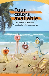 Mini cartoon fan with flexible tripod on a creative summer beach scenery setup