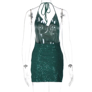 Detailed close-up of green sequin texture and halter tie on an open-back mini dress