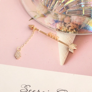 Arrow industrial barbell with orange beads, delicate chain, and Hamsa hand charm