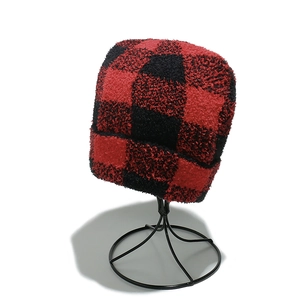 Close-up of red and black buffalo plaid fuzzy knit beanie with soft plush texture