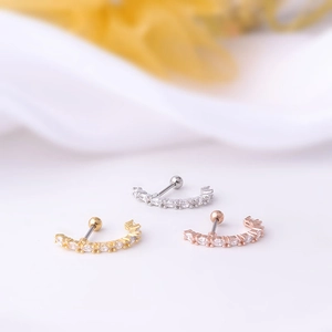Three curved stainless steel ear studs with cubic zirconia in silver, gold, and rose gold