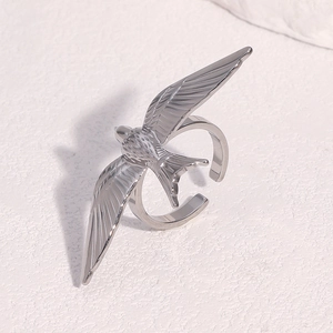 Macro detail of silver swallow bird ring with polished wing texture and adjustable band