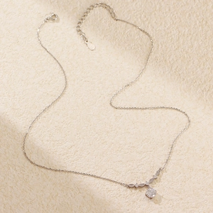 Macro detail of S925 silver necklace featuring a round zircon and adjustable chain link