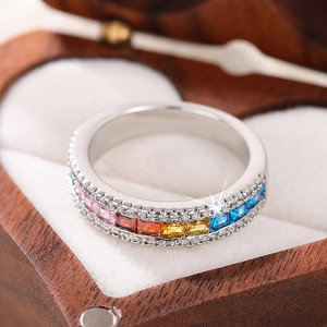 Macro view of colorful zircon ring with square gemstones in a heart jewelry box
