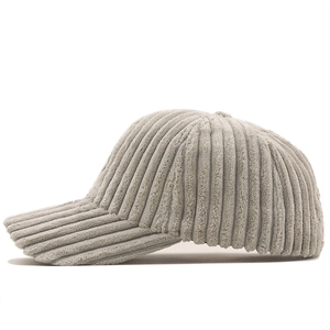 Detailed side view of light grey corduroy baseball cap texture and six-panel stitching