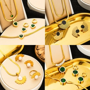Detail of gold-plated stainless steel jewelry sets with green gems, pearls, and black stones
