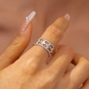 Detailed macro view of silver hollow floral ring with milgrain bead edges for women
