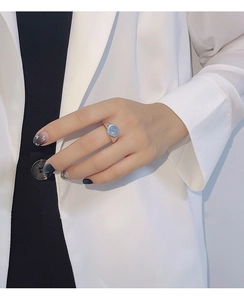 Detail of S925 silver ring featuring geometric circles and engraved star on female hand