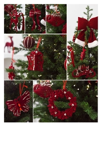 Close-up of red flocked reindeer and bell Christmas tree ornaments with gold glitter