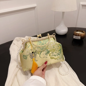 Elegant Chinese style shell bag with floral embroidery, pearl handle, and yellow tassel