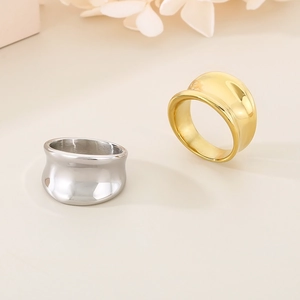 Macro shot of minimalist wide irregular titanium steel rings in gold and silver polished finish
