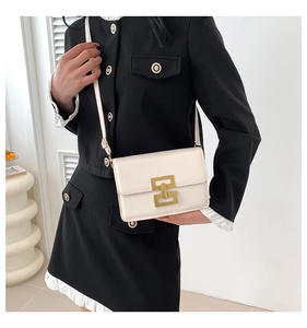 Detail of white rectangular crossbody bag with golden metal buckle on black suit