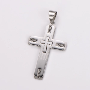 Detail shot of silver stainless steel cross pendant with Greek key pattern and relief cross