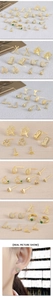 Detailed macro view of gold plated tree of life and heart stud earrings set with zircon