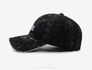 Detail of distressed charcoal grey baseball cap showing blue S embroidery and ripped fabric