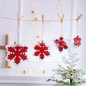 Set of red and white Christmas snowflake ornaments with wooden clips and hemp ropes