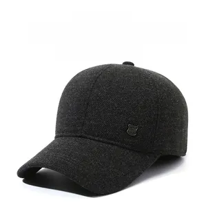 Detailed view of dark grey winter baseball cap with thick wool texture and side metal badge