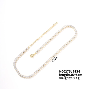 Detail of gold tennis necklace with white zircon stones showing lobster clasp and chain