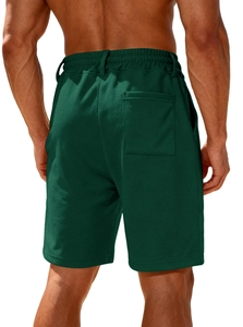 Detail view of men's dark green sports shorts showing back pocket and breathable fabric texture