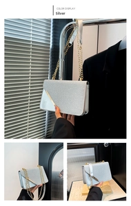 Detail of silver sequin crossbody bag featuring a golden triangle metal trim and chain
