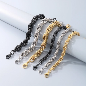 Detailed view of triple hip-hop twisted chains in gold silver and black steel finishes