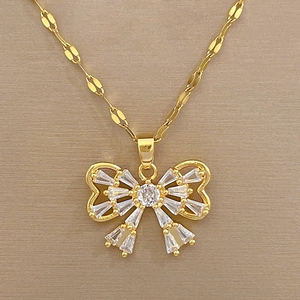 Detailed macro view of gold butterfly pendant featuring micro-pave crystals and zircon stones
