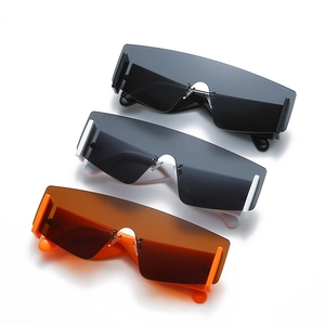 Oversized one-piece shield sunglasses in black, white and orange on white background