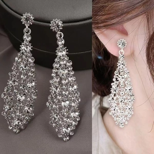 Detailed close-up and model view of shiny silver irregular rhinestone tassel earrings