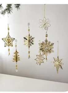Macro view of six gold metal Christmas snowflake and star ornaments with crystal drops