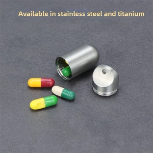 Macro detail of waterproof titanium medicine capsule with screw cap and hanging loop