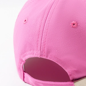 Detailed view of pink cotton baseball cap back with metal buckle and stitching