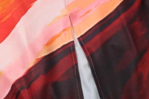 Close-up detail showing the side slit design and abstract floral print on fabric