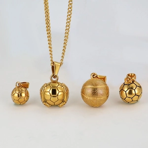 Detailed view of 24k gold-plated soccer and basketball pendants on white background