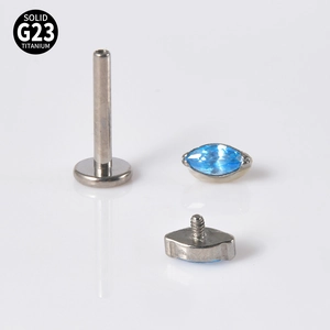Detailed view of G23 titanium labret with marquise-cut blue opal inlay on white background