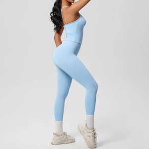Detail of high-waist sky blue yoga leggings and racerback sports bra on a female model