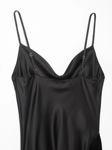 Detail showing high-quality black satin dress with spaghetti straps and draped neckline