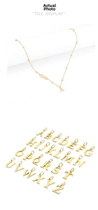 Detail of gold letter A pendant necklace and full A-Z alphabet charms display