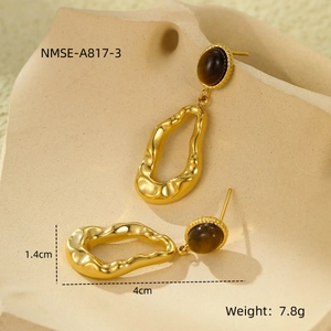 Macro shot of gold stainless steel earrings with tiger eye stone and dimensions
