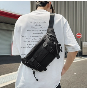 Close-up of black crossbody bag with adjustable buckle and multi-pocket functional design