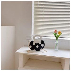 Creative heart-shaped crossbody bag with black and white polka dots and gold chain strap
