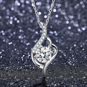 Detail of silver wave pendant featuring a round moissanite in six-prong setting